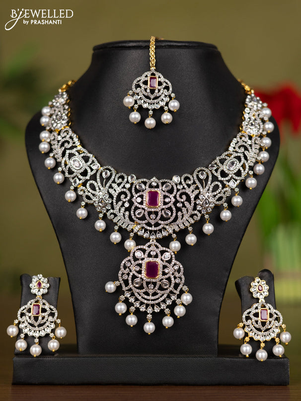 Zircon necklace with maang tikka ruby & cz stones and pearl hangings in gold finish