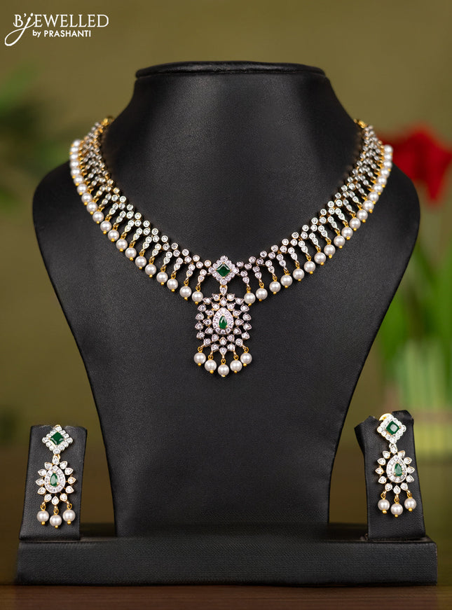 Zircon necklace with emerald & cz stones and pearl hangings in gold finish