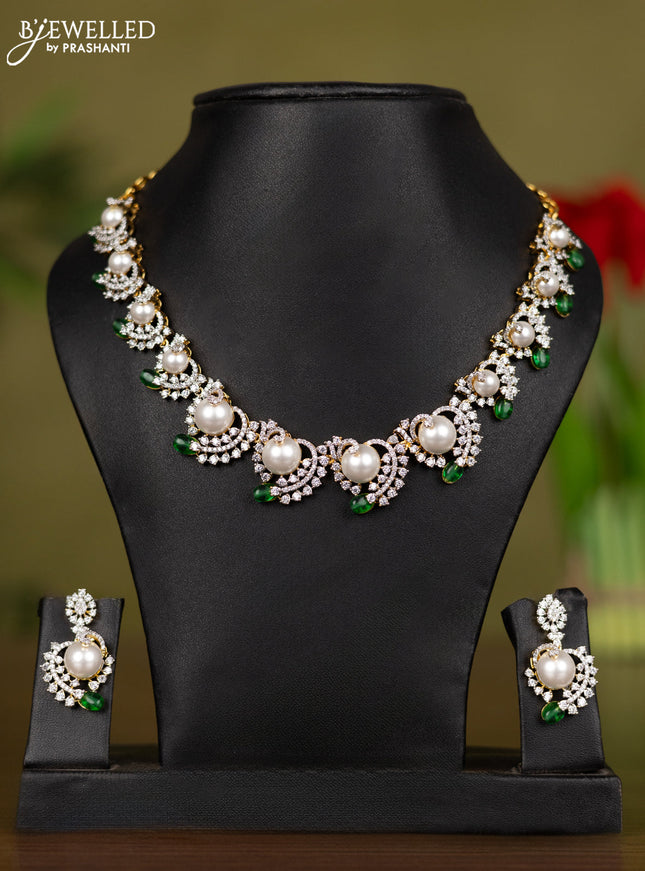 Zircon necklace with cz stones and pearl & green beads in gold finish