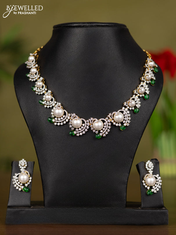 Zircon necklace with cz stones and pearl & green beads in gold finish