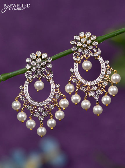 Zircon earrings with cz stones and pearl hangings in gold finish