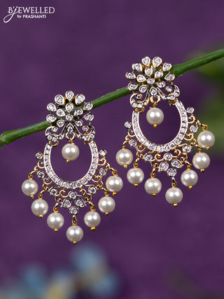 Zircon earrings with cz stones and pearl hangings in gold finish