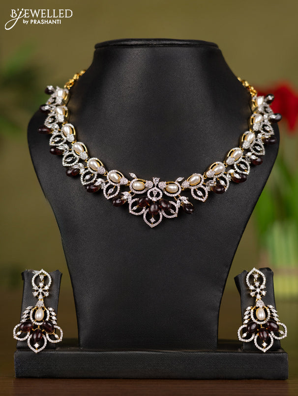 Zircon necklace with cz stones and pearl & brown beads in gold finish