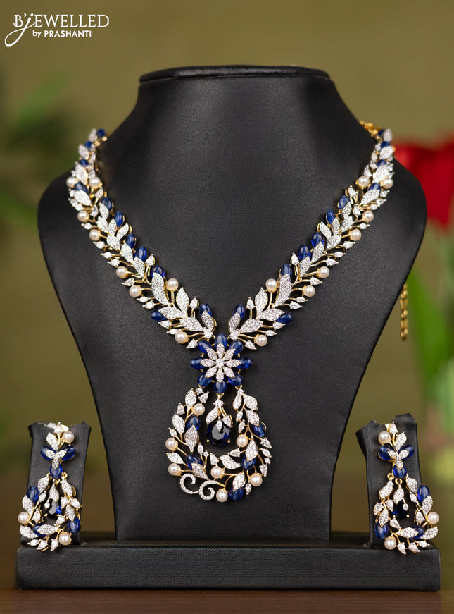 Zircon necklace with cz stones and pearl & blue beads in gold finish