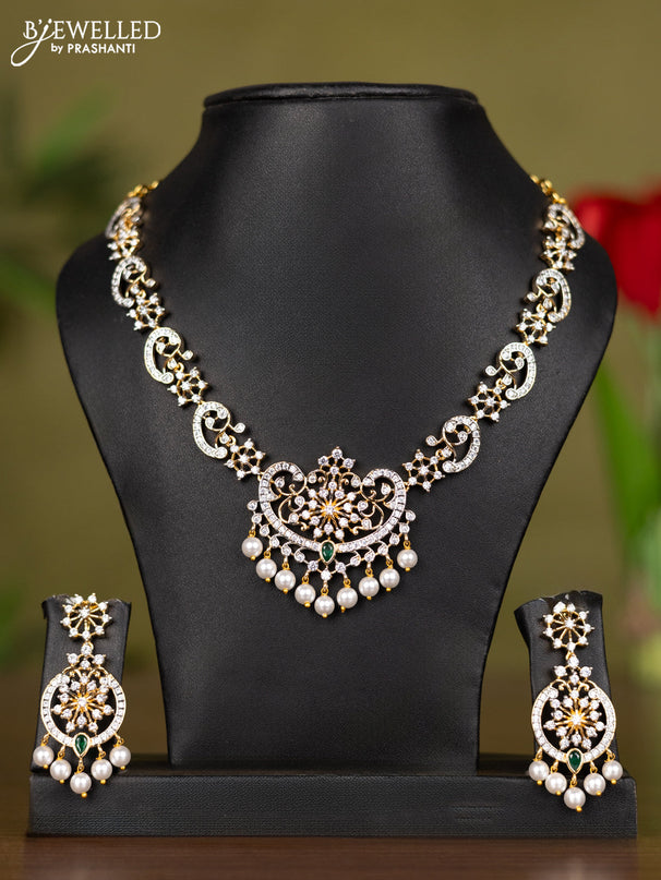 Zircon necklace with emerald & cz stones and pearl hangings in gold finish