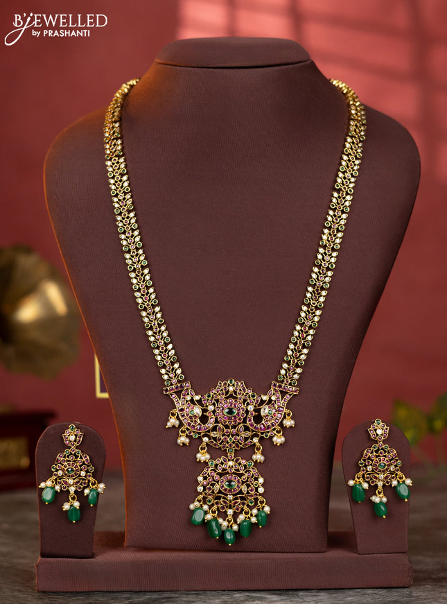 Antique haaram with double peacock design in kemp and white stones & green beads hanging