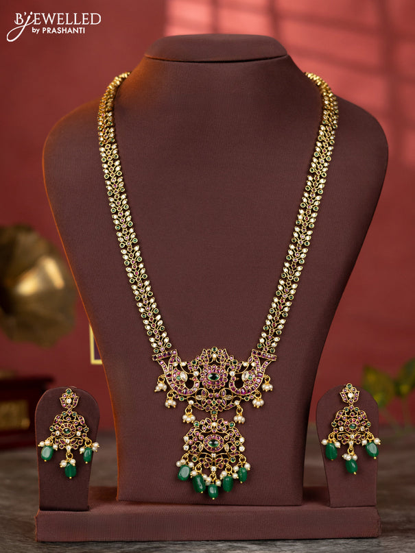 Antique haaram with double peacock design in kemp and white stones & green beads hanging