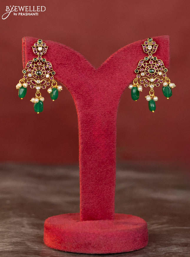 Antique haaram with double peacock design in kemp and white stones & green beads hanging