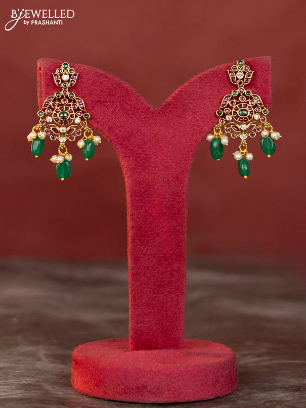 Antique haaram with double peacock design in kemp and white stones & green beads hanging