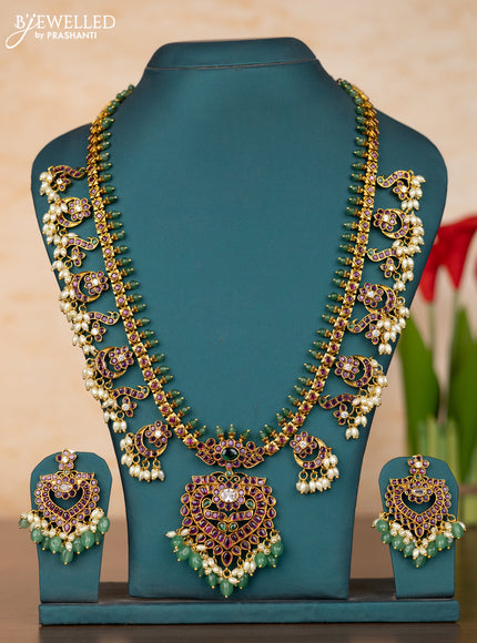 Antique guttapusalu haaram with floral pendant and peacock design in kemp stones and rice pearl hanging