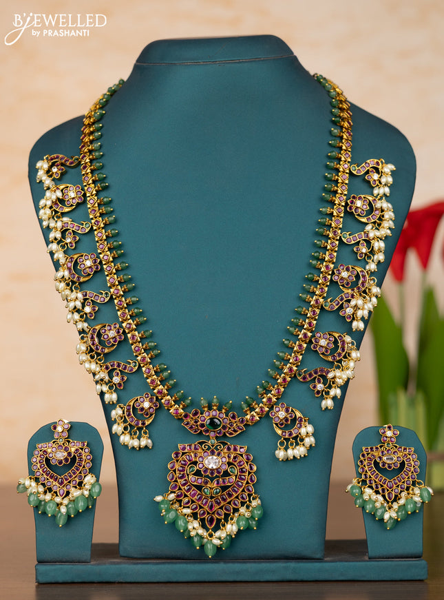 Antique guttapusalu haaram with floral pendant and peacock design in kemp stones and rice pearl hanging