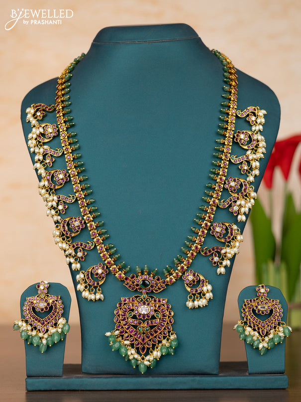 Antique guttapusalu haaram with floral pendant and peacock design in kemp stones and rice pearl hanging