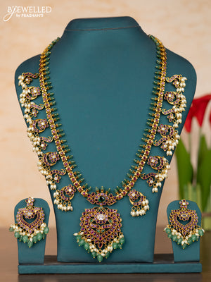 Antique guttapusalu haaram with floral pendant and peacock design in kemp stones and rice pearl hanging