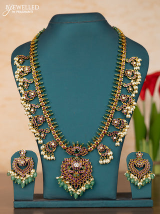 Antique guttapusalu haaram with floral pendant and peacock design in kemp stones and rice pearl hanging
