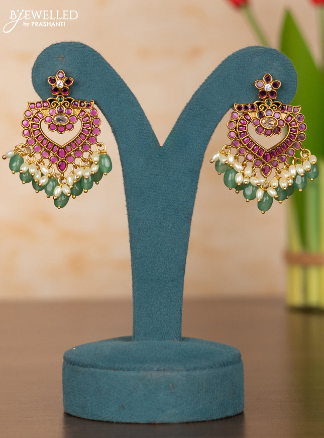 Antique guttapusalu haaram with floral pendant and peacock design in kemp stones and rice pearl hanging