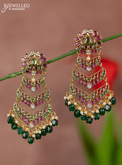 Antique earrings with floral deisgn and three step model in kemp stones and green beads hanging