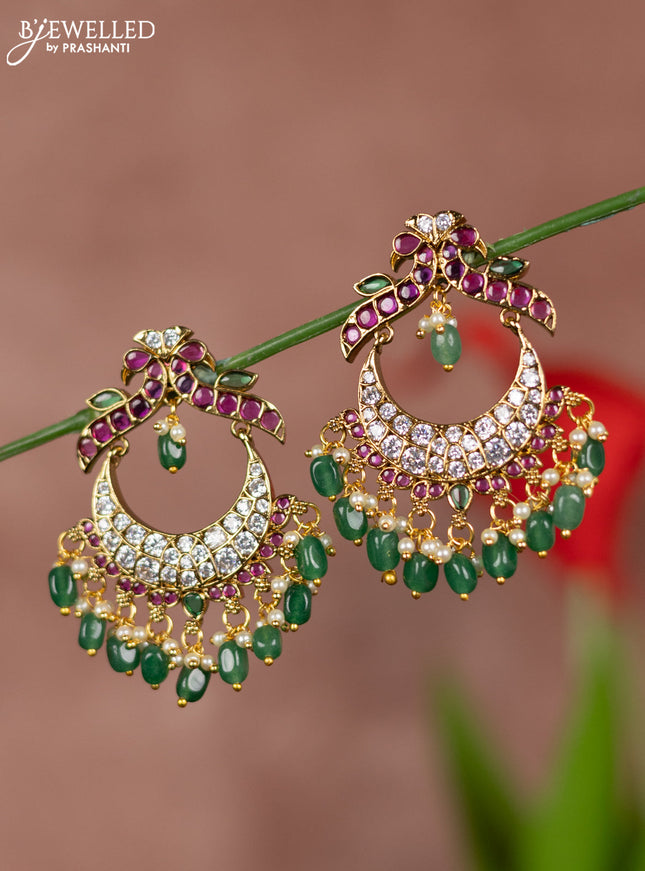 Antique earrings with double peacock deisgn in kemp and white stones  & green beads hanging