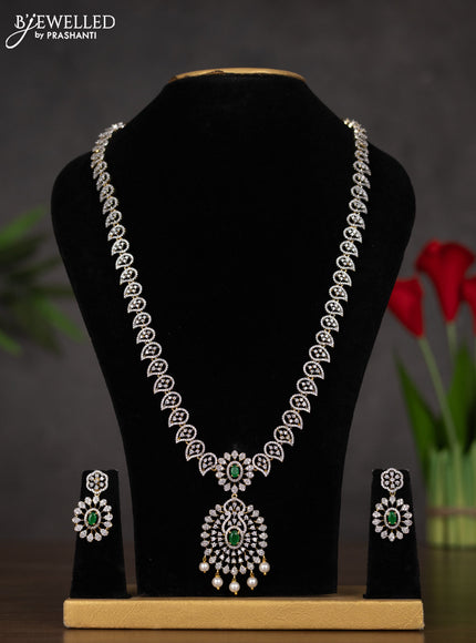 Zircon haaram with emerald & cz stones and pearl hangings in gold finish