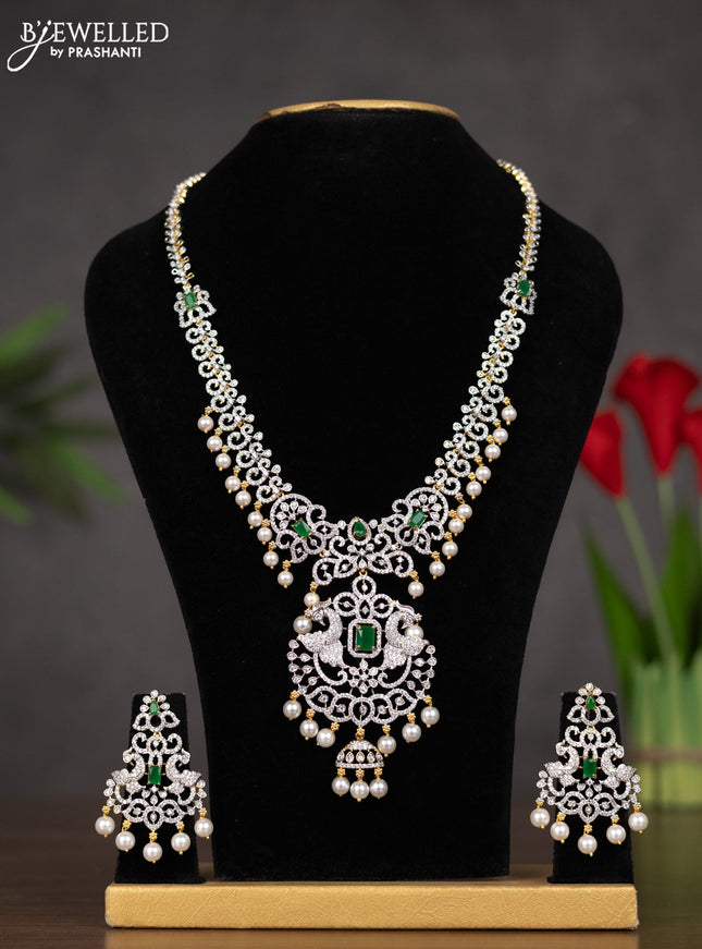 Zircon haaram peacock design with emerald & cz stones and pearl hangings in gold finish
