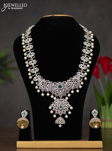Zircon haaram with emerald & cz stones and pearl hangings in gold finish