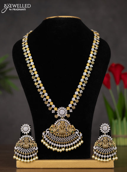 Zircon haaram lakshmi design with emerald & cz stones and pearl hangings in gold finish