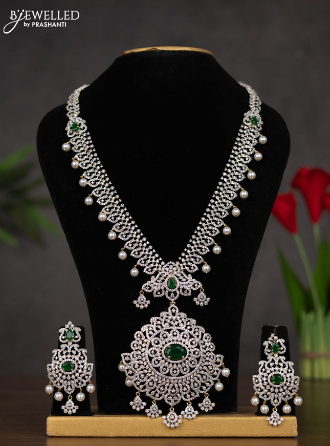 Zircon haaram with emerald & cz stones and pearl hangings in gold finish