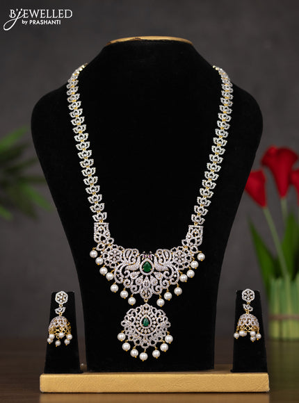 Zircon haaram with emerald & cz stones and pearl hangings in gold finish