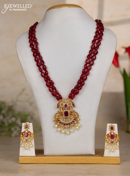 Beaded maroon necklace with double peacock design in white and ruby stones and pearl hanging