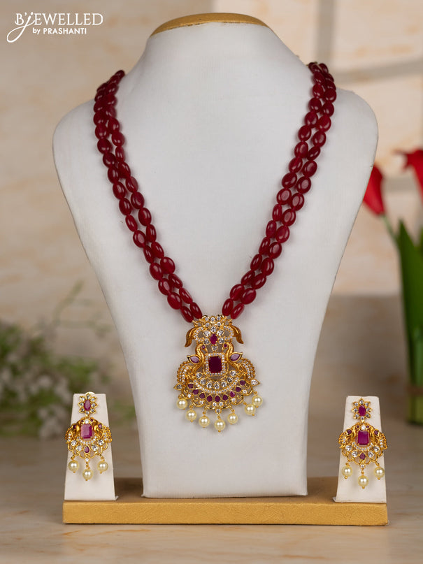 Beaded maroon necklace with double peacock design in white and ruby stones and pearl hanging