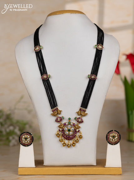Beaded black necklace with floral pendant in kemp and golden beads hanging