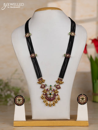Beaded black necklace with floral pendant in kemp and golden beads hanging
