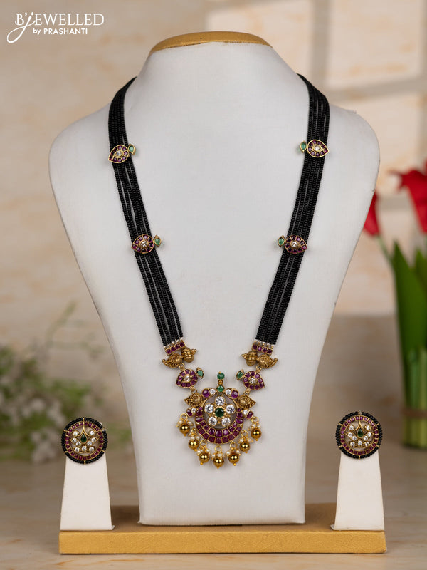 Beaded black necklace with floral pendant in kemp and golden beads hanging
