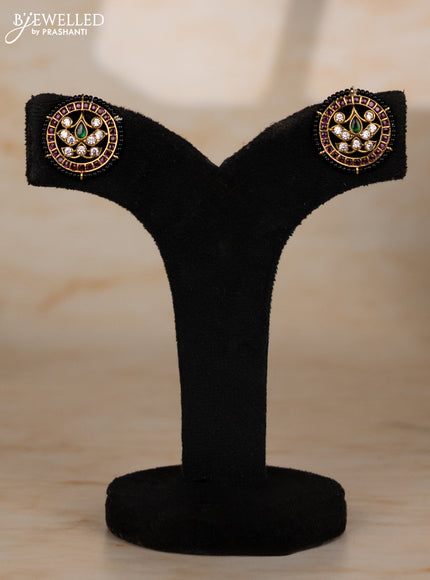 Beaded black necklace with floral pendant in kemp and golden beads hanging