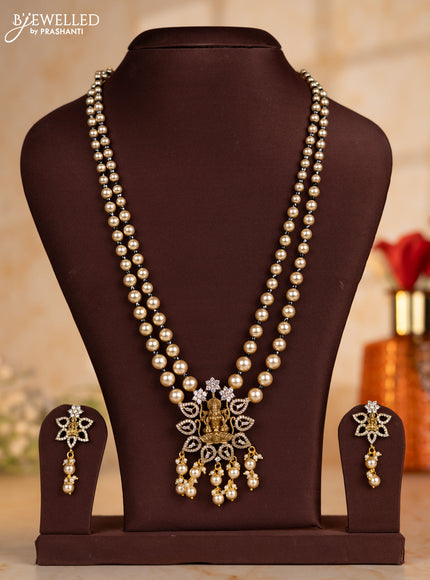 Pearl necklace with black beads and lakshmi pendant with cz stones and pearl hanging