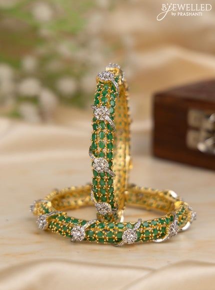 Zircon bangles with emerald stones in gold finish
