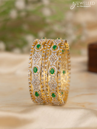 Zircon bangles with emerald and cz stones in gold finish
