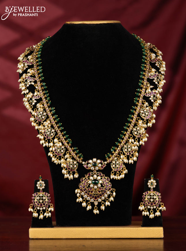 Antique Guttapusalu Haaram with peacock pendnat and floral design in multicolor kemp stones and rice pearl hangings