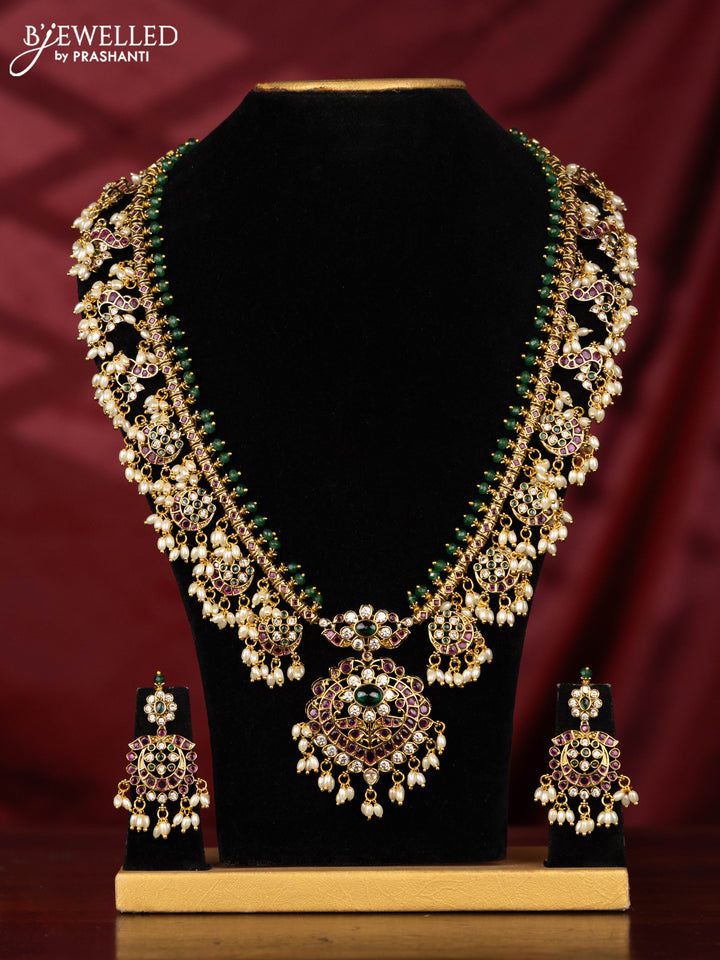 Antique Guttapusalu Haaram with peacock pendnat and floral design in multicolor kemp stones and rice pearl hangings