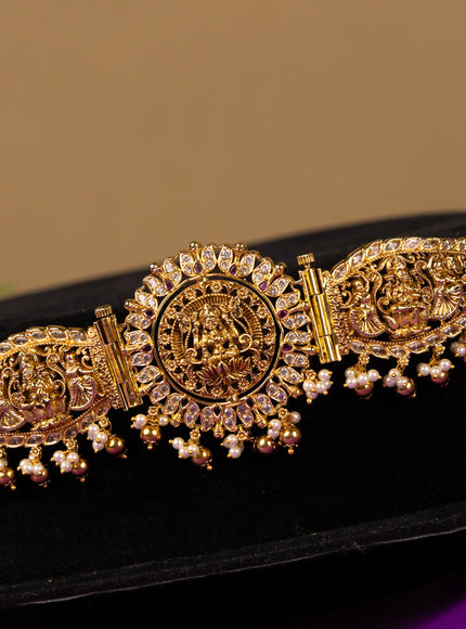 Antique hip belt with rotating lakshmi and peacock pendant in white and red stones and pearl hanging with removable pendant