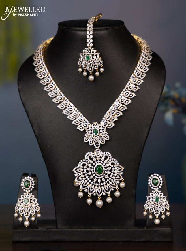 Zircon necklace leaf deisgn with cz and green stone with maang tikka in gold finish