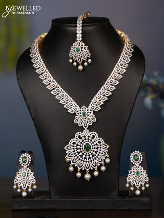 Zircon necklace leaf deisgn with cz and green stone with maang tikka in gold finish