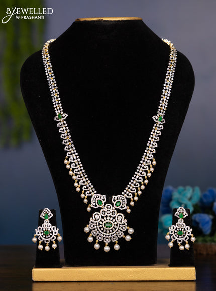 Zircon haaram with emerald & cz stones and pearl hangings in gold finish