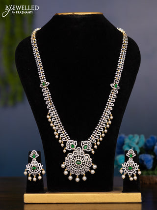 Zircon haaram with emerald & cz stones and pearl hangings in gold finish