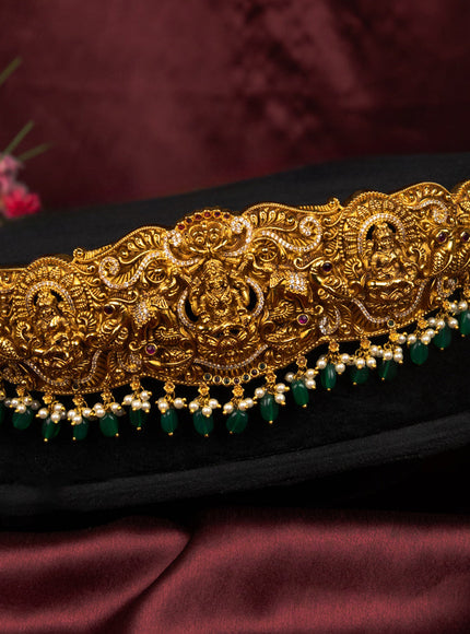 Antique self emboss hip belt lakshmi pendant with kemp & cz stones and pearl &beads hangings