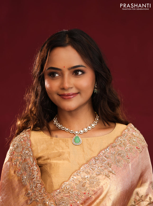 Pastel pink pure kanchipuram tissue silk saree with allover embroidery