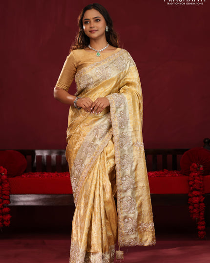 Gold Pure kanchipuram tissue silk saree with allover zari weaves & embroidery