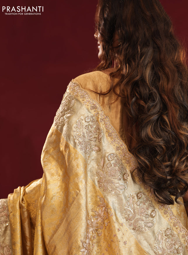 Gold Pure kanchipuram tissue silk saree with allover zari weaves & embroidery