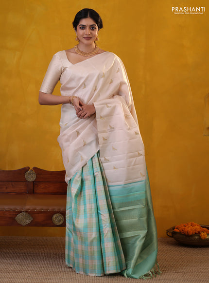 Off white-Teal blue Pure Kanchipuram silk saree With Zari woven peacock buttas