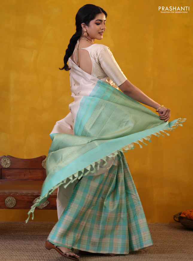 Off white-Teal blue Pure Kanchipuram silk saree With Zari woven peacock buttas