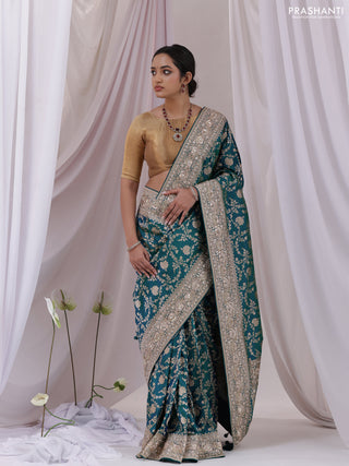 Teal Blue Banarasi Uppada silk saree with allover zari weaves & embroidery border